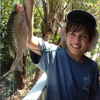 A young angler shows off his catch.