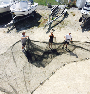 People hold a large net.