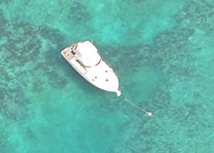 aerial view of a boat tied to a mooring buoy