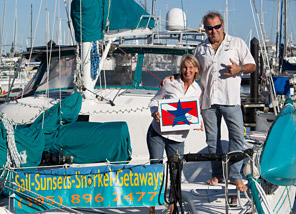 Cindy Lou Thor and Rick Super aboard a boat holding the bluestar logo