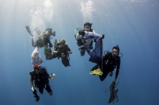 Divers clean up marine debris from reefs