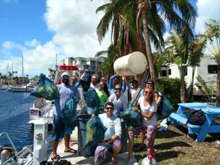group photo on a boat with marine debris that was collected