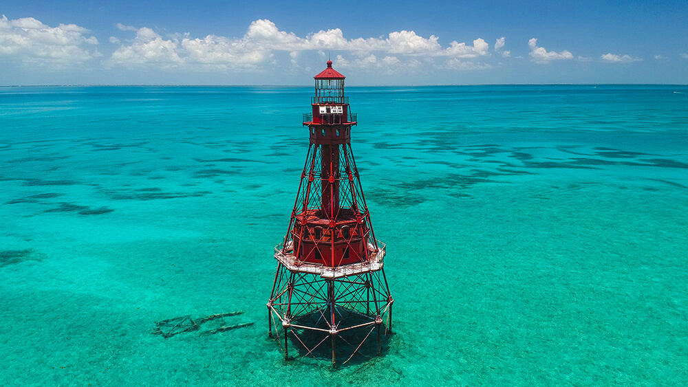A lighthouse in clear shallow water