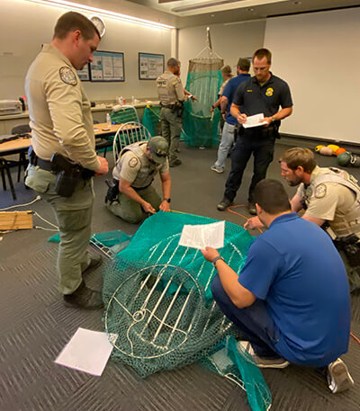 Officers examine nets in a training session