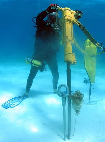 diver using a drill on the seafloor
